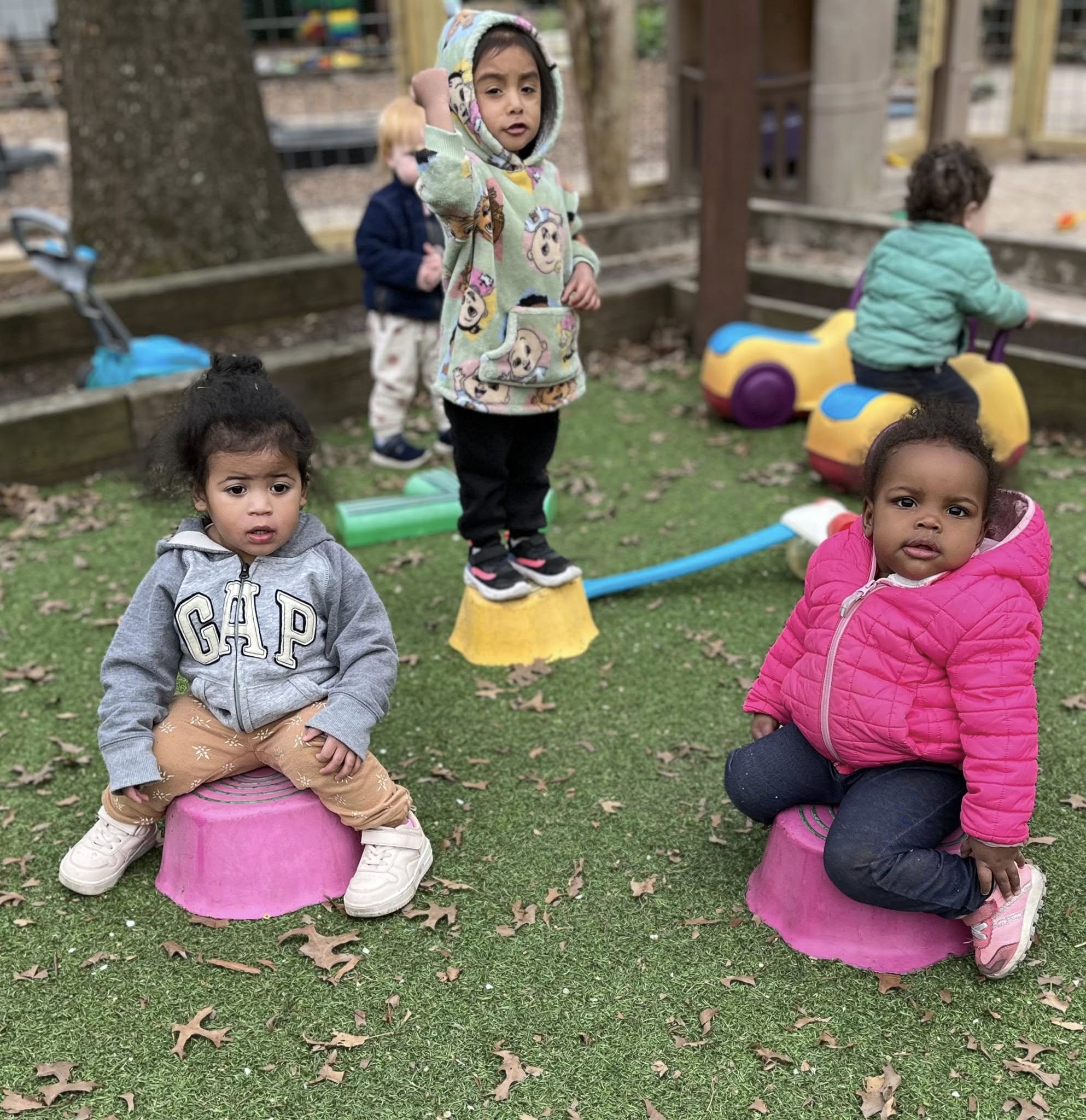 babies and toddler in schoolyard